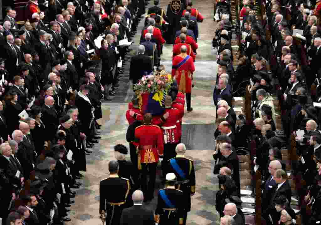 King Charles III, Camilla, the Queen Consort, Princess Anne, and her husband Vice Admiral Tim Laurence and Prince Andrew follow the coffin of Queen Elizabeth is being carried into Westminster Abbey for her funeral in central London, Sept. 19, 2022. 