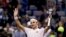 FILE - Roger Federer of Switzerland waves to spectators after prevailing in a singles match at Qizhong Forest Sports City Tennis Center in Shanghai, China, Oct. 10, 2018. 