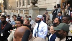 Adnan Syed, center, leaves the Elijah E. Cummings Courthouse, in Baltimore, Sept. 19, 2022. A judge has ordered the release of Syed after overturning his conviction for a 1999 murder that was chronicled in the hit podcast “Serial.” 