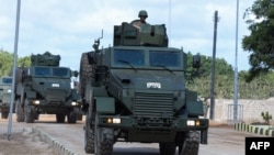 FILE - A Somalia National Army (SNA) soldier rides on an armored personnel carrier, in Mogadishu, April 12, 2022. Somali army troops and local militias recently expelled al-Shabab militants from the town of Adan Yabal in the Middle Shabelle region.