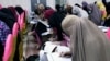 FILE - Bburqa-clad Afghan women take an entrance test at Mamon Tahiri institute in Kandahar, Afghanistan.