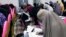 FILE - Bburqa-clad Afghan women take an entrance test at Mamon Tahiri institute in Kandahar, Afghanistan.