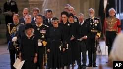 Camilla, Queen Consort, Princess Anne, Prince Edward, Prince William, Prince Andrew, Tim Laurence, Peter Phillips, Sophie, Countess of Wessex, Catherine, Princess of Wales, Meghan, Dutchess of Sussex, are seen inside the Palace of Westminster as the First