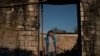 Alina Orobchenko stands at the door of her house that was destroyed after a Russian attack last month in Prudyanka village, Ukraine, Sept. 18, 2022. "It's really hard to decide what to do next," she says. "It's impossible to plan for the future."