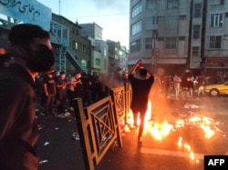 A picture obtained by AFP outside Iran on Sept. 21, 2022, shows Iranian demonstrators taking to the streets of Tehran during a protest for Mahsa Amini, days after she died in police custody.