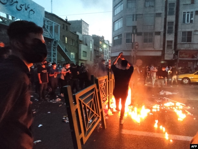 A picture obtained by AFP outside Iran on Sept. 21, 2022, shows Iranian demonstrators taking to the streets of Tehran during a protest for Mahsa Amini, days after she died in police custody.