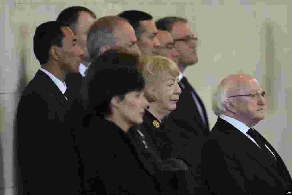 President of Ireland Michael D Higgins, right, pays his respects to Queen Elizabeth II, as her coffin lie in state on the catafalque in Westminster hall in London, Sept. 18, 2022.