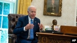 FILE - U.S. President Joe Biden speaks during an interview in the Oval Office of the White House, in Washington, June 16, 2022. 