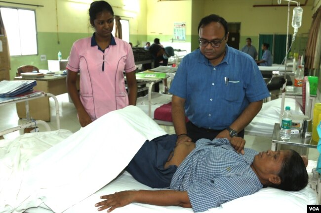 Gynecologist Dr Mayoukh Chakraborty, examining a female patient at KPC Medical College & Hospital in Kolkata.