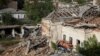 Destroyed houses and cars are seen in the town of Izium, recently liberated by Ukrainian Armed Forces, in Kharkiv region, Ukraine, Sept. 20, 2022.