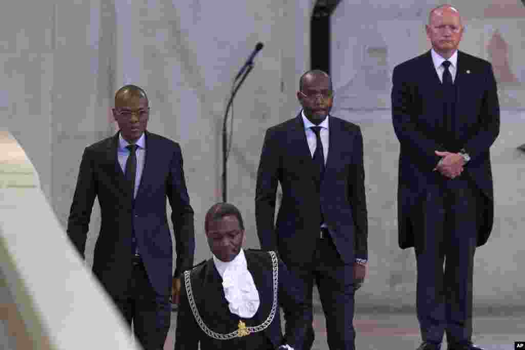 Chad&#39;s Minister of Petroleum and Energy, Djerassem Le Bemadjiel, left, arrives to pay his respects to Queen Elizabeth II inside Westminster Hall in London, Sept. 18, 2022.