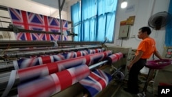 A worker produces British flags at the Shaoxing Chuangdong Tour Articles Co. factory in Shaoxing, in eastern China's Zhejiang province, Sept. 16, 2022. 