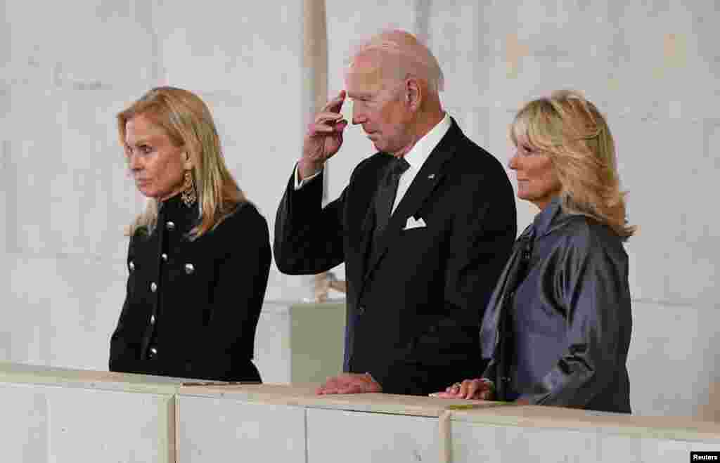 U.S. President Joe Biden and First Lady Jill Biden (right) view the coffin of Queen Elizabeth II, lying in state on the catafalque in Westminster Hall in London, Sept. 18, 2022.