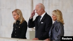 President Joe Biden and first lady Jill Biden (right) view the coffin of Queen Elizabeth II, lying in state on the catafalque in Westminster Hall in London, Sept. 18, 2022.