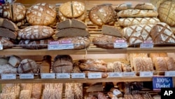 FILE - Bread with price tags waits for customers in the market hall in Frankfurt, Germany, June 14, 2022. European bread prices were 18% higher in August 2022 than a year earlier, Eurostat reported. 