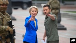 FILE - Ukrainian President Volodymyr Zelenskyy, right, and European Commission President Ursula von der Leyen talk during her visit to Kyiv, Ukraine, Sept. 15, 2022.