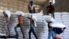 FILE - Laborers at the World Food Program warehouse in Adama town, Ethiopia, offload bags of grains as part of relief food that was sent from Ukraine, Sept. 8, 2022.