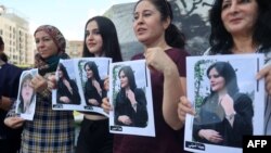FILE - Kurdish and Lebanese women take part in a rally in Beirut, Sept. 21, 2022, days after the Iranian authorities announced the death of Mahsa Amini, who had been held in Tehran for allegedly wearing a hijab in an "improper" way.