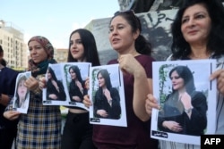 FILE - Kurdish and Lebanese women take part in a rally in Beirut, Sept. 21, 2022, days after the Iranian authorities announced the death of Mahsa Amini, who had been held in Tehran for allegedly wearing a hijab in an "improper" way.