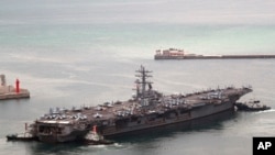 U.S. aircraft carrier USS Ronald Reagan leaves from a port in Busan, South Korea, Sept. 26, 2022.