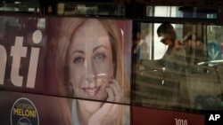 A poster of Italy's candidate premier Giorgia Meloni is seen on the side of a bus, in Rome, Sept. 16, 2022.