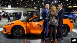 President Joe Biden talks with Mary Barra, CEO of General Motors, during a tour of the Detroit Auto Show, Sept. 14, 2022, in Detroit.