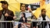 A demonstrator in New York holds a picture of Mahsa Amini, who died in police custody in Iran, Sept. 22, 2022.