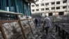 A woman walks in front of a destroyed building in Kramatorsk, in the Donetsk region, Sept. 18, 2022.