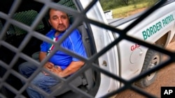 A 38-year-old man from Mexico City sits in a U.S. Border Patrol vehicle, Sept. 8, 2022, near Sasabe, Arizona.