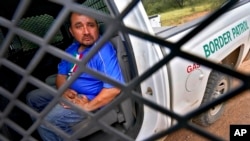 A 38-year-old man from Mexico City sits in a U.S. Border Patrol vehicle, Sept. 8, 2022, near Sasabe, Ariz. after being rescued by a U.S. Border Patrol agent. He nearly died atop Baboquivari Peak after developing debilitating foot blisters with no food or water.