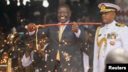 Kenya's President William Ruto displays the special sword that he received to represent his instruments of power and authority from his predecessor Uhuru Kenyatta after his official swearing-in ceremony at Moi International Stadium Kasarani in Nairobi, Ke