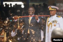 President Ruto displays the special sword that he received to represent his instruments of power and authority from his predecessor Uhuru Kenyatta after his official swearing-in ceremony at Moi International Stadium Kasarani in Nairobi, Sept. 13, 2022.