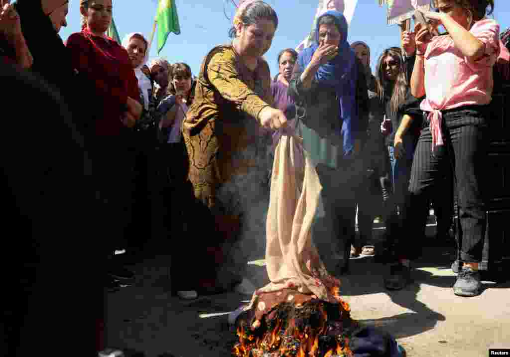 Women burn headscarves during a protest over the death of 22-year-old Kurdish woman Mahsa Amini in Iran, in the Kurdish-controlled city of Qamishli, northeastern Syria.&nbsp;Amini died earlier this month while in the custody of Tehran&rsquo;s morality police.