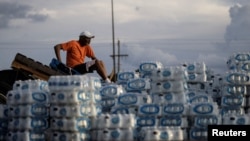 FILE - Phillip Young, from Jackson, Miss., takes a break while helping local volunteers distribute bottles of water as the city of Jackson and areas around were going without reliable drinking water, Aug. 31, 2022.