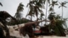 A man stands amidst debris on the seashore in the aftermath of Hurricane Fiona in Punta Cana, Dominican Republic, Sept. 19, 2022. 