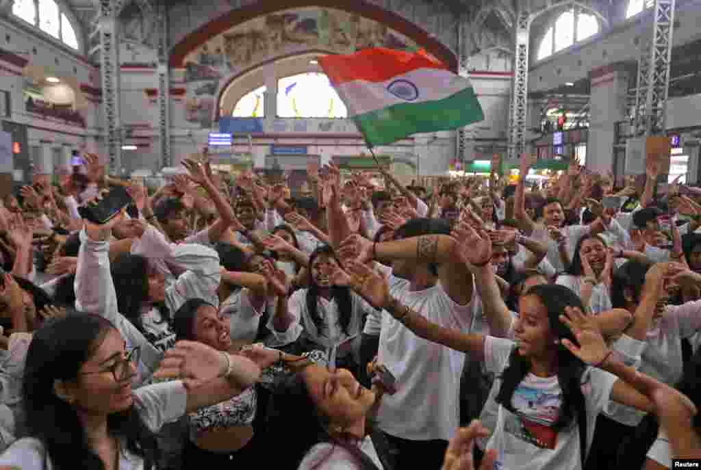 College students perform during a group dance in recognition of the the cultural diversity of India, at Mumbai Central railway station, in Mumbai.