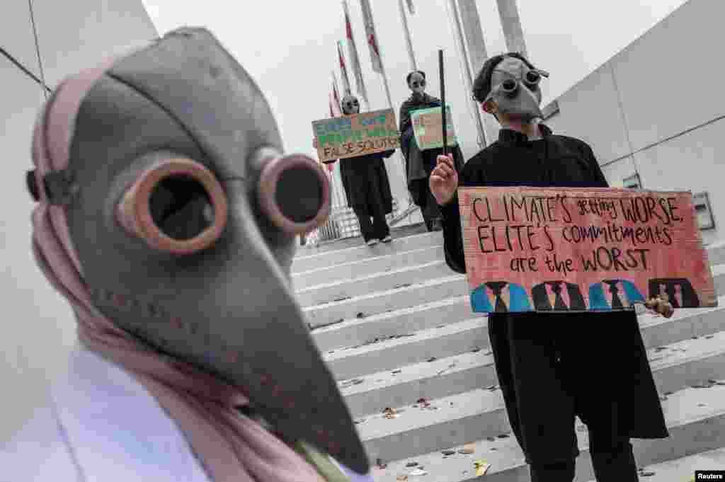 Environmental activists wearing masks carry placards during a Global Climate Strike rally in Jakarta, Indonesia. (Antara Foto/Aprillio Akbar/via Reuters)