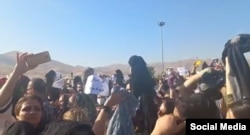 FILE - A screenshot of video circulating on social media purports to show women in Saghez, Iran, removing their headscarves in protest against the death of 22-year-old Mahsa Amini, who died after being detained by morality police enforcing strict hijab rules.