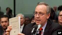 FILE - Independent counsel Kenneth Starr holds a copy of his report while testifying on Capitol Hill, Nov. 19, 1998, before the House Judiciary Committee's impeachment hearing during the Clinton presidency.