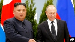 FILE - Russian President Vladimir Putin, right, and North Korea's leader Kim Jong Un shake hands during their meeting in Vladivostok, Russia, April 25, 2019.