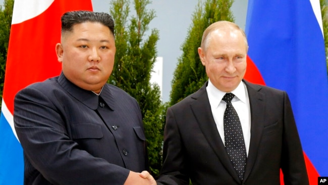 FILE - Russian President Vladimir Putin, right, and North Korea's leader Kim Jong Un shake hands during their meeting in Vladivostok, Russia, April 25, 2019.