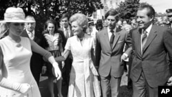 FILE - First lady Pat Nixon leads Princess Anne, as President Richard Nixon and Prince Charles walk with them, at the White House, July 16, 1970.