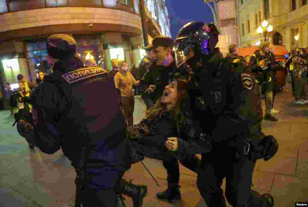 Russian police officers detain a protester during an unsanctioned rally, after opposition activists called for street protests against the mobilization of reservists ordered by President Vladimir Putin, in Moscow.