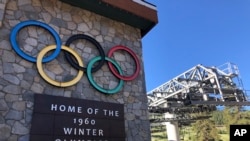 FILE - A sign marking the 1960 Winter Olympics is seen by a chairlift at what was then called Squaw Valley Ski Resort, July 9, 2020, in Olympic Valley, Calif.