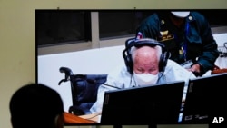 Khieu Samphan, former Khmer Rouge head of state, is seen on screen during his verdict announcement at the U.N.-backed war crimes tribunal in Phnom Penh, Cambodia, Sept. 22, 2022. 