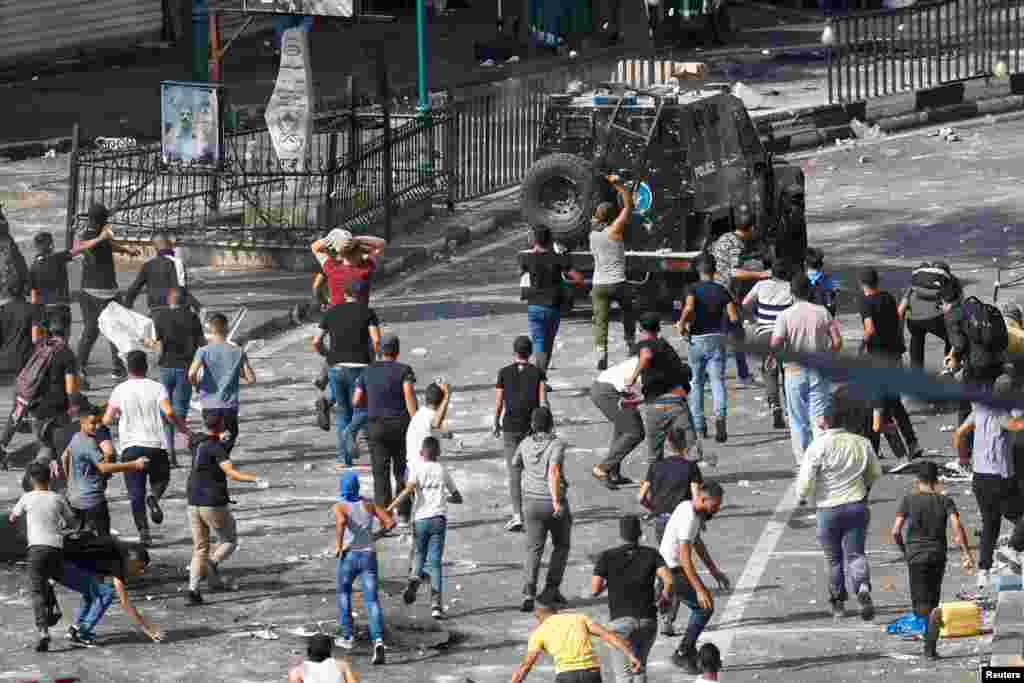 Palestinian demonstrators protesting the arrest of two Palestinian militants clash with Palestinian security forces, in Nablus in the Israeli-occupied West Bank.