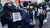 Protesters hold placards in south west London on January 9, 2022 to demonstrate against the 'dramatic deterioration of press freedom' in Hong Kong.