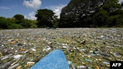 Plastic residues, glass and other materials are seen at the Cerron Grande reservoir in Potonico, El Salvador, on Sept. 9, 2022. 