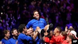 Team Europe's Roger Federer is lifted by fellow players after playing with Rafael Nadal in a Laver Cup doubles match against Team World's Jack Sock and Frances Tiafoe at the O2 arena in London, Sept. 23, 2022.
