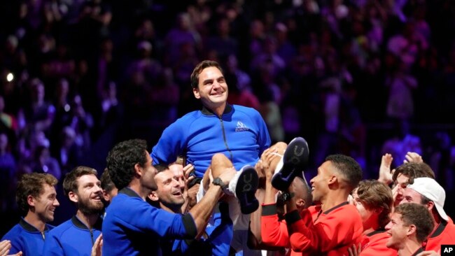 Team Europe's Roger Federer is lifted by fellow players after playing with Rafael Nadal in a Laver Cup doubles match against Team World's Jack Sock and Frances Tiafoe at the O2 arena in London, Sept. 23, 2022.